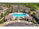 Aerial view of community pool area featuring palm trees and ample lounge seating at 5407 River Rock Rd # 5407, Lakeland, FL 33809