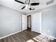 This bedroom features wood-look flooring, gray walls, and closet with bi-fold doors at 5458 Quarry Rock Rd, Lakeland, FL 33809