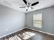 Bedroom featuring neutral walls, wood-look flooring, and a ceiling fan with overhead lighting at 5458 Quarry Rock Rd, Lakeland, FL 33809