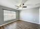 Cozy bedroom with wood floors, ceiling fan, and natural light at 5458 Quarry Rock Rd, Lakeland, FL 33809