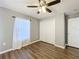 Bedroom featuring wood-look flooring, neutral walls, and a closet with sliding doors at 5458 Quarry Rock Rd, Lakeland, FL 33809