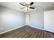 Neutral bedroom features wood-look flooring, gray walls, and ceiling fan with lights at 5458 Quarry Rock Rd, Lakeland, FL 33809