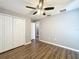 Bedroom featuring a ceiling fan, wood floors, and large closet at 5458 Quarry Rock Rd, Lakeland, FL 33809