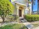 Charming home entrance featuring a columned porch and well-maintained landscaping at 5458 Quarry Rock Rd, Lakeland, FL 33809