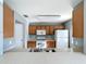 Open kitchen with appliances, shaker cabinets, and a view to the Gathering room at 5458 Quarry Rock Rd, Lakeland, FL 33809