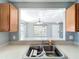 Kitchen sink with bar height counter looking through to living room with natural light at 5458 Quarry Rock Rd, Lakeland, FL 33809