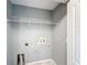 A utilitarian laundry room features painted walls and a wire rack shelf for organized storage at 5458 Quarry Rock Rd, Lakeland, FL 33809