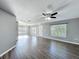 Spacious living room featuring wood floors, lots of natural light, and a ceiling fan at 5458 Quarry Rock Rd, Lakeland, FL 33809