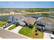 Aerial view of residences in a lakeside community with well-manicured lawns and a scenic water feature at 5543 Arlington River Dr, Lakeland, FL 33811