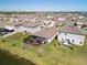 An aerial view showcases the home's screened patio and the surrounding neighborhood at 5543 Arlington River Dr, Lakeland, FL 33811