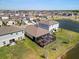 Backyard with screened patio and view of the pond in this aerial shot of the property and community at 5543 Arlington River Dr, Lakeland, FL 33811