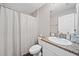 Cozy bathroom featuring a granite countertop, white cabinets, and a shower with white curtains at 5543 Arlington River Dr, Lakeland, FL 33811