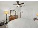 Bright bedroom featuring carpeted floors, a ceiling fan, and an antique dresser with a mirror at 5543 Arlington River Dr, Lakeland, FL 33811