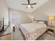 Light-filled bedroom with a ceiling fan, carpet, and a patterned comforter; bright windows create a cozy feel at 5543 Arlington River Dr, Lakeland, FL 33811