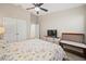 Bedroom featuring a ceiling fan, television, carpet, and large bed with coastal-themed bedding at 5543 Arlington River Dr, Lakeland, FL 33811