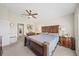 Primary bedroom featuring a ceiling fan, large bed, neutral carpet, and windows providing abundant natural light at 5543 Arlington River Dr, Lakeland, FL 33811