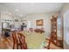 This dining area offers wood flooring, a large table, and a glimpse into the adjacent, modern kitchen at 5543 Arlington River Dr, Lakeland, FL 33811