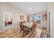 Light-filled dining room features hardwood floors, an elegant table set, and plenty of natural light from the large windows at 5543 Arlington River Dr, Lakeland, FL 33811