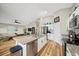 Open kitchen featuring stainless steel appliances, granite countertops and views of the living room at 5543 Arlington River Dr, Lakeland, FL 33811