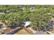 Aerial view of a cozy home surrounded by lush greenery and mature trees in a serene neighborhood at 605 Forrest Dr, Bartow, FL 33830