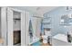 Bright blue bathroom features a walk-in shower, closet, and ample counter space at 605 Forrest Dr, Bartow, FL 33830