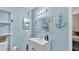 Light blue bathroom featuring an anchor decoration, toilet, and plenty of counter space at 605 Forrest Dr, Bartow, FL 33830