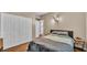 Bedroom with light walls, wood floor, side tables, and large closet at 605 Forrest Dr, Bartow, FL 33830