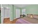 Bedroom featuring green walls, door to closet and bathroom, and a small desk at 605 Forrest Dr, Bartow, FL 33830