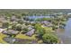 Aerial view of a lakeside home with screened pool in a mature residential neighborhood at 6775 Lake Clark Dr, Lakeland, FL 33813