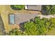 Aerial view showing roof, screened in pool, and surrounding trees at 6775 Lake Clark Dr, Lakeland, FL 33813