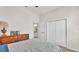 Bright bedroom featuring neutral walls, carpet, and a wooden dresser topped with decor at 6775 Lake Clark Dr, Lakeland, FL 33813