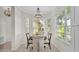 Cozy dining area bathed in natural light, featuring a round table and scenic water view at 6775 Lake Clark Dr, Lakeland, FL 33813