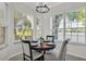 Cozy dining area bathed in natural light, featuring a round table and scenic water view at 6775 Lake Clark Dr, Lakeland, FL 33813