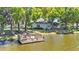 Dock on the water surrounded by mature trees and landscaping at 6775 Lake Clark Dr, Lakeland, FL 33813