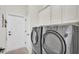 Laundry room featuring white cabinets and a modern washer and dryer at 6775 Lake Clark Dr, Lakeland, FL 33813