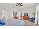 Spacious main bedroom with ceiling fan, with en suite bath in view through the door at 6775 Lake Clark Dr, Lakeland, FL 33813