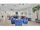 Bright sitting area with blue chairs, large windows, and a view into the living room at 6775 Lake Clark Dr, Lakeland, FL 33813