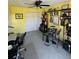 Bedroom with yellow walls, ceiling fan, closet, desk, and electronic drum set at 8181 Bristol Bay Ave, Lakeland, FL 33810