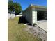 Exterior side view of the home showing access to the garage and the AC unit at 8181 Bristol Bay Ave, Lakeland, FL 33810