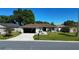 Well-maintained single-story home featuring a lush green lawn, driveway, and an attached garage at 8181 Bristol Bay Ave, Lakeland, FL 33810