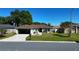 Well-maintained single-story home featuring a lush green lawn, driveway, and an attached garage at 8181 Bristol Bay Ave, Lakeland, FL 33810