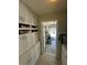 View into the garage through a storage room with lots of white cabinets at 8181 Bristol Bay Ave, Lakeland, FL 33810