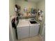 Functional laundry room equipped with washer, dryer, and plenty of shelving for storage at 8181 Bristol Bay Ave, Lakeland, FL 33810