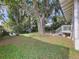 Sprawling backyard with patio area, shed, mature trees, and seating, perfect for outdoor gatherings at 923 Lexington St, Lakeland, FL 33801