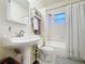 Clean bathroom with a pedestal sink and combination shower and tub at 923 Lexington St, Lakeland, FL 33801