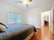 Cozy bedroom featuring hardwood floors, natural light, and a neutral color scheme, creating a relaxing atmosphere at 923 Lexington St, Lakeland, FL 33801