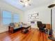 Bedroom with wood floors, futon, ceiling fan, built in shelves and lots of natural light at 923 Lexington St, Lakeland, FL 33801