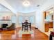 Dining area with hardwood floors, leading to a kitchen and living room, enhanced by bright natural light and stylish decor at 923 Lexington St, Lakeland, FL 33801