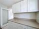 Traditional kitchen featuring all white cabinets, neutral countertops, and a pass-through to another room at 923 Lexington St, Lakeland, FL 33801