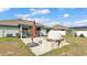 Backyard showcasing a pizza oven, shed, green lawn, and an orange umbrella at 955 Hunters Meadow Ln, Lakeland, FL 33809